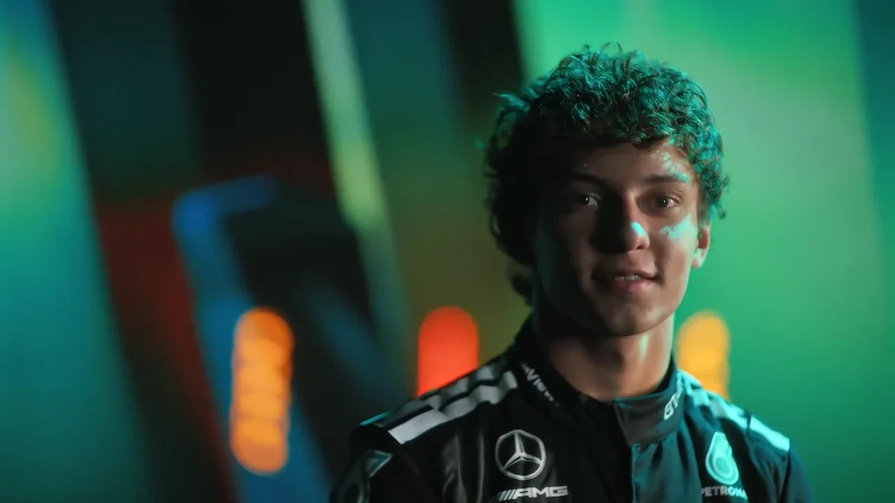 Kimi Antonelli in his Mercedes racing suit, lit by teal and orange light in the G42 project film.