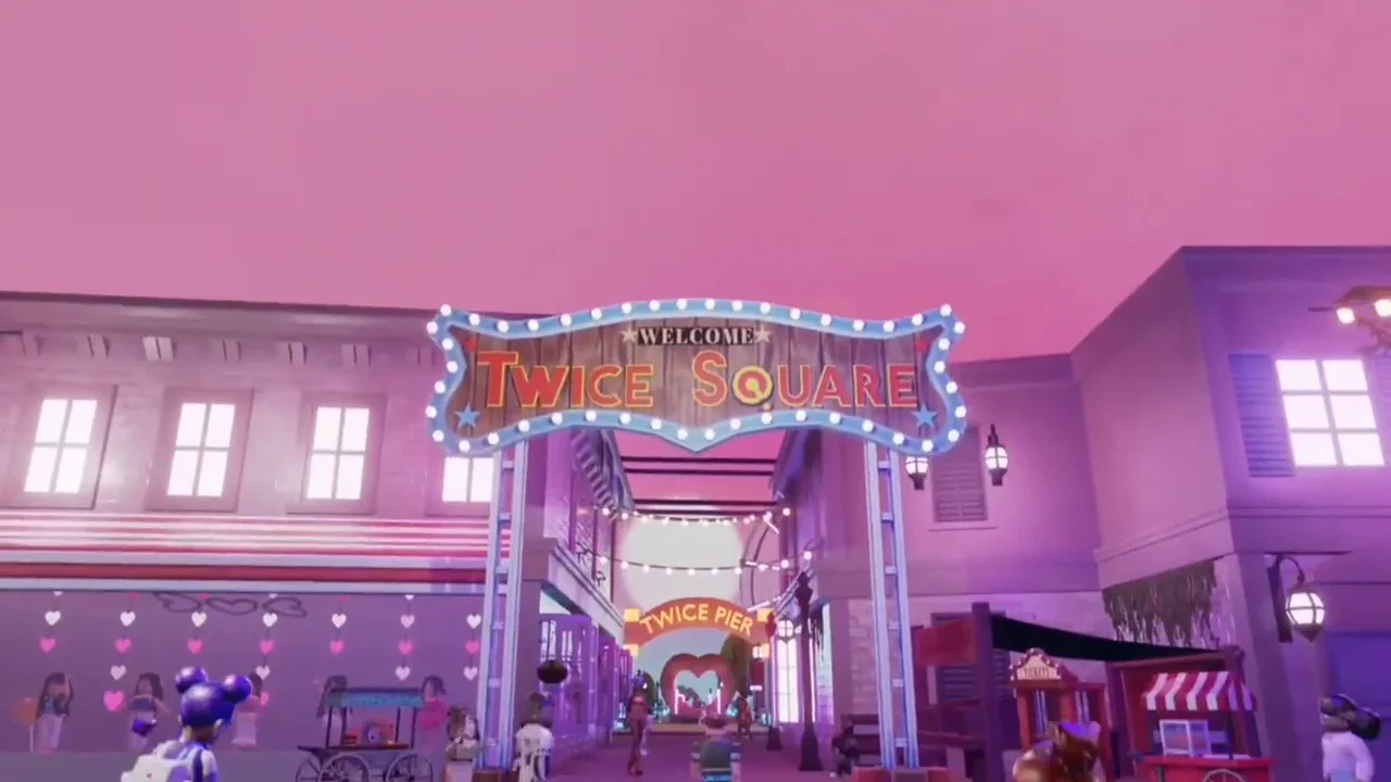 The illuminated TWICE Square entrance with fans gathered beneath its sign.