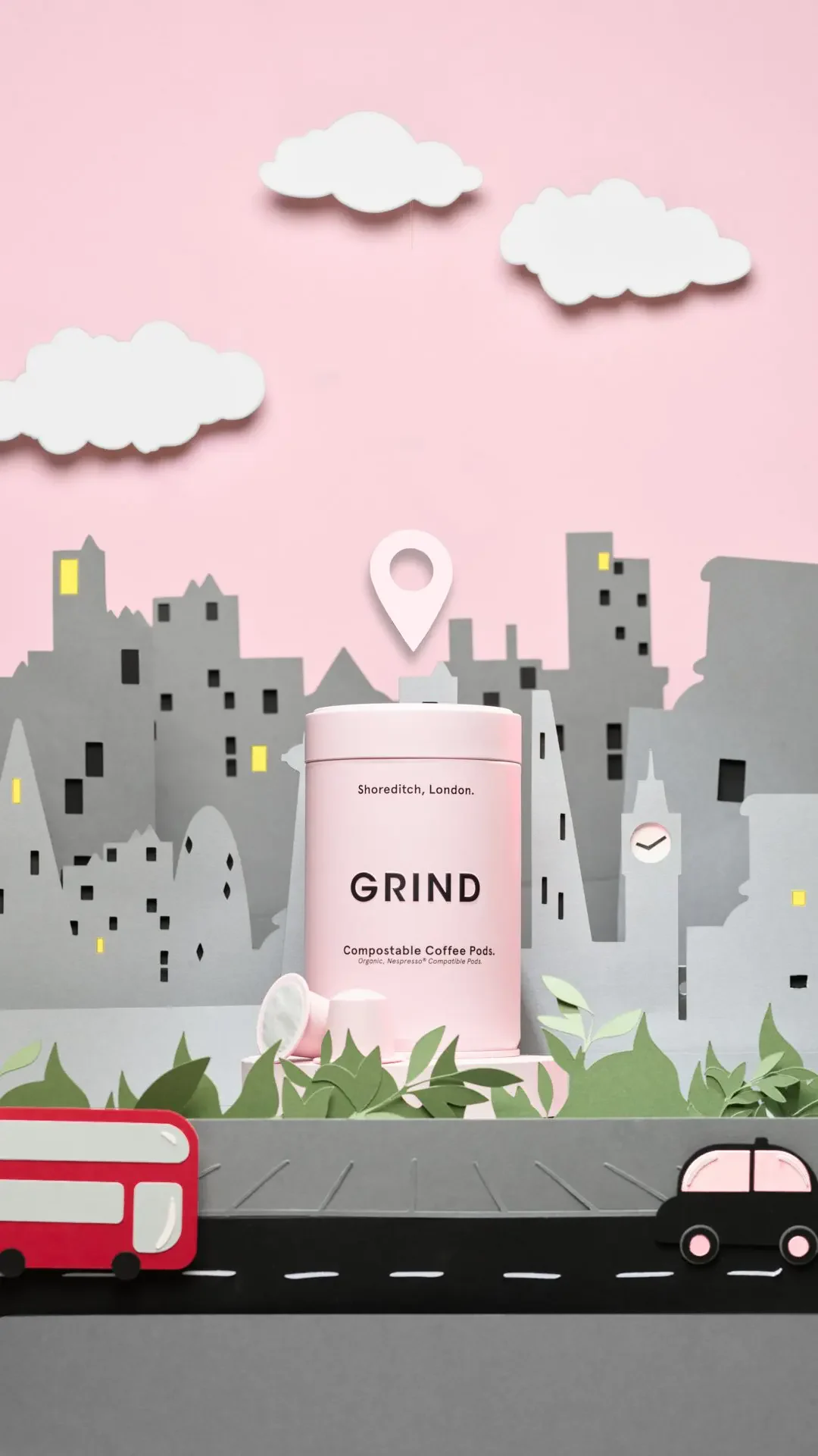 A GRIND tin surrounded by paper buildings, clouds and London traffic.