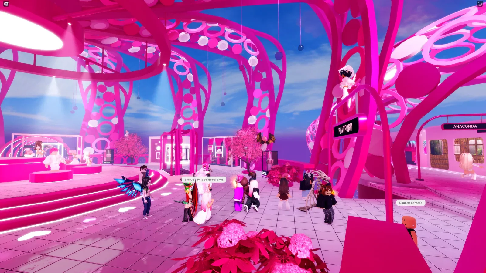 Roblox characters gather among pink trees and branded storefronts.