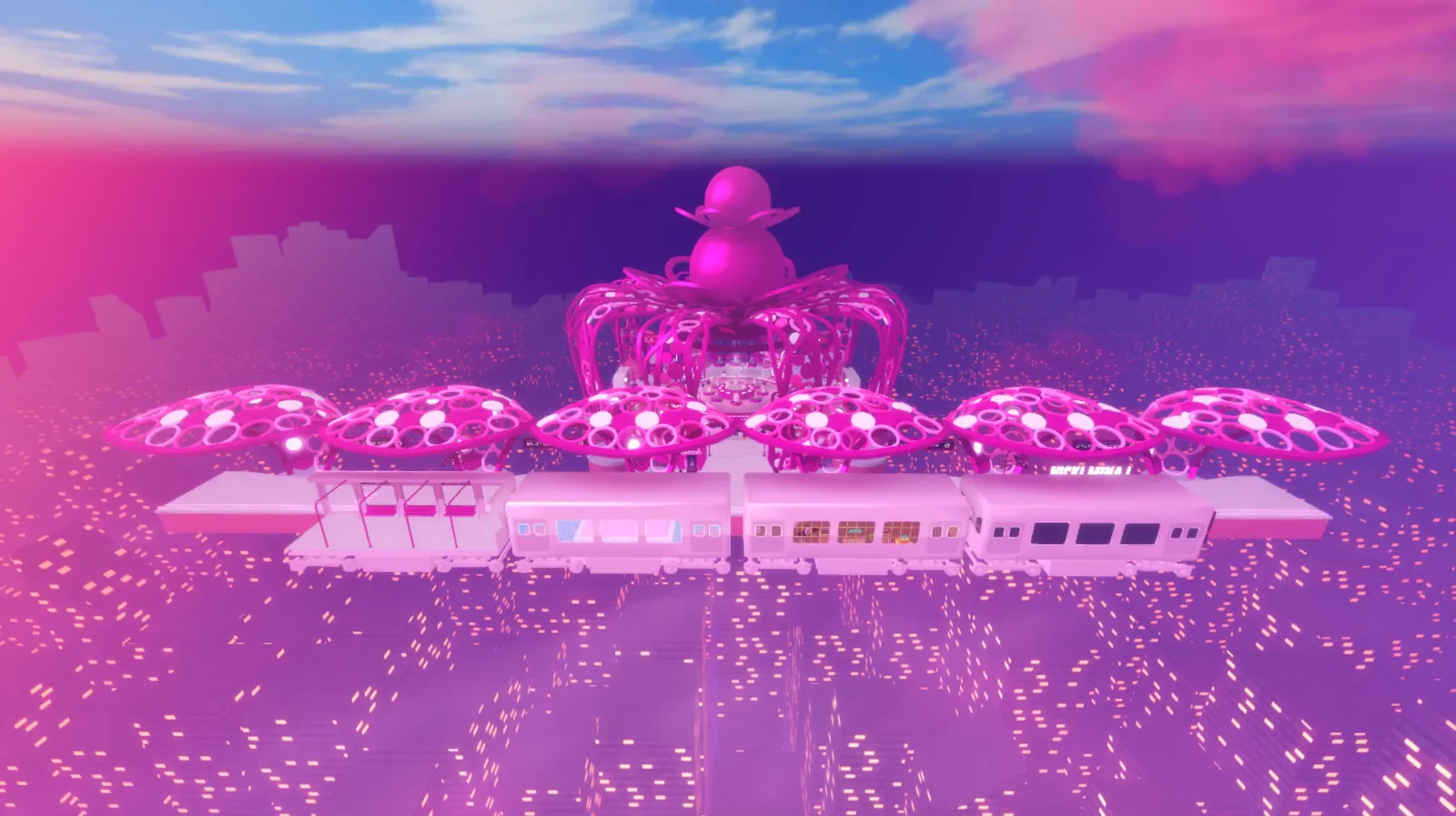 Nicki Minaj’s pink Gag City concert setting with a large crowd and a stage above the skyline.