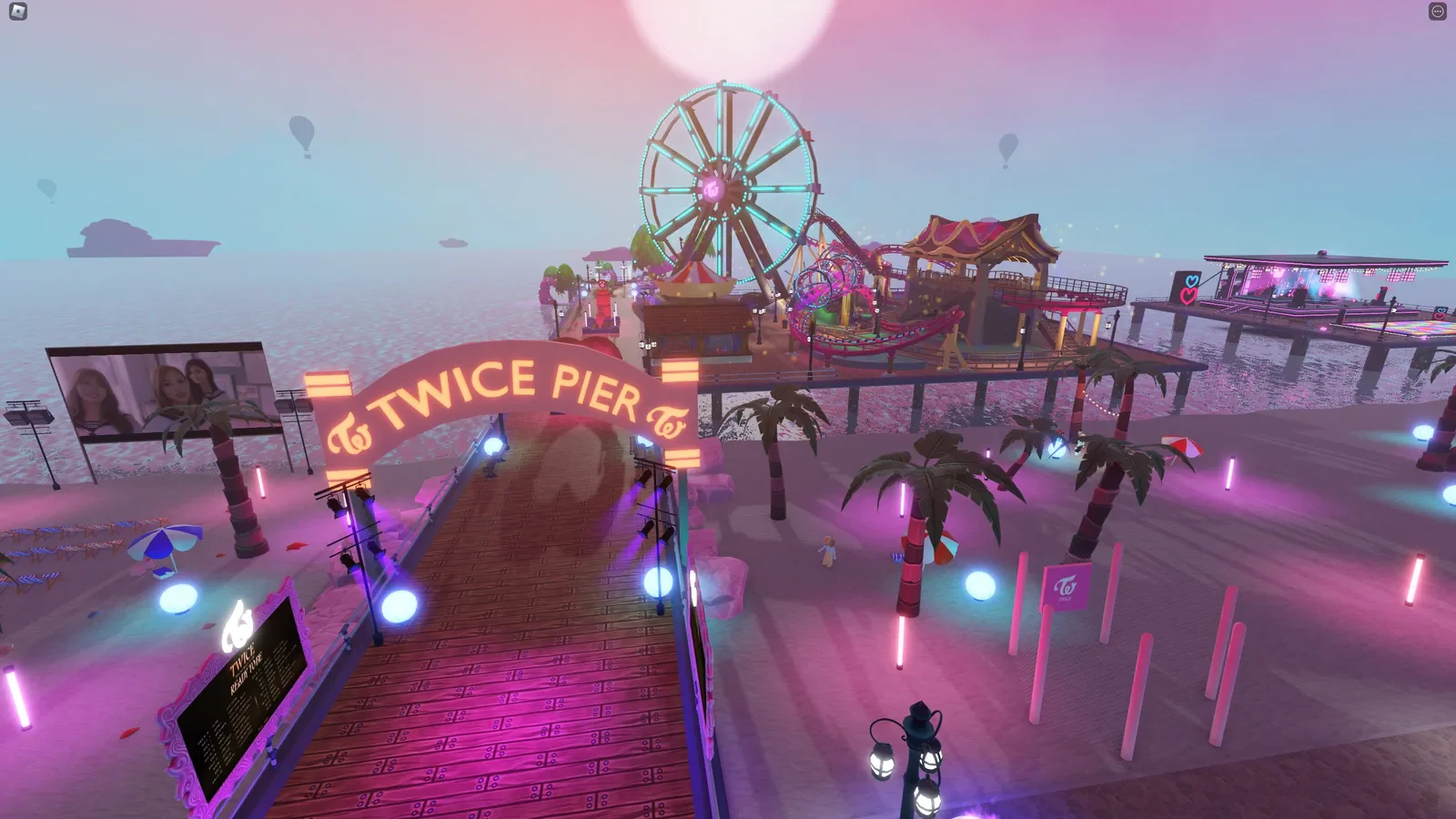 An elevated view of TWICE Pier and its glowing seaside attractions.