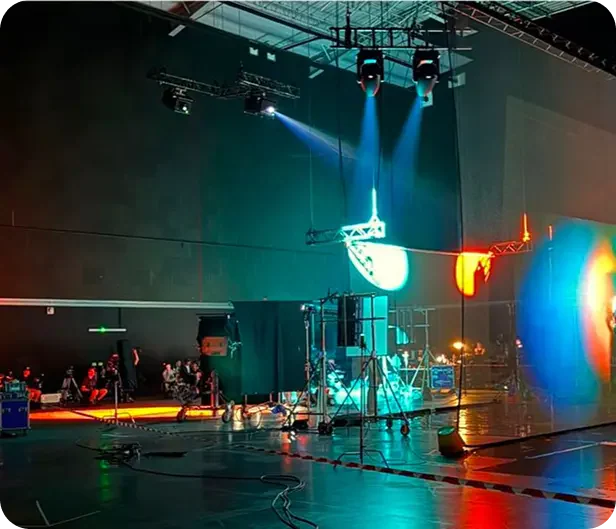 Illuminated screens and holographic display equipment inside the event venue.