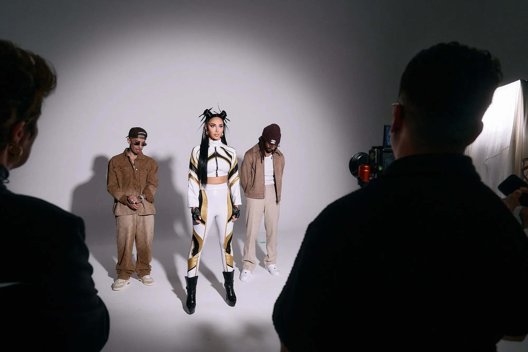 Dappy, Tulisa and Fazer together on the studio set, with the camera in the foreground.