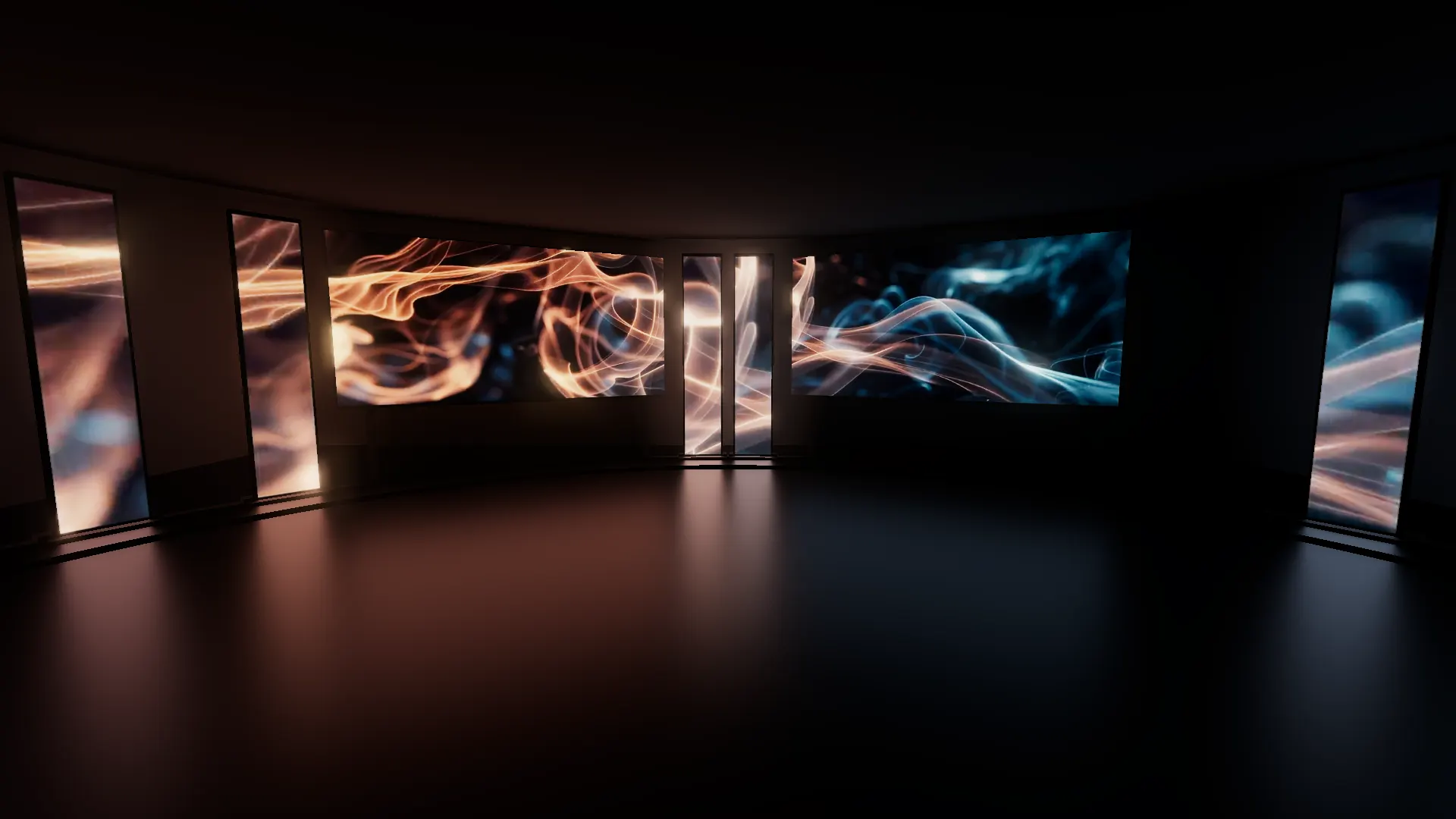 A black room seen from inside: two main screens in front and LED columns curving round both sides, all showing orange and blue visuals.