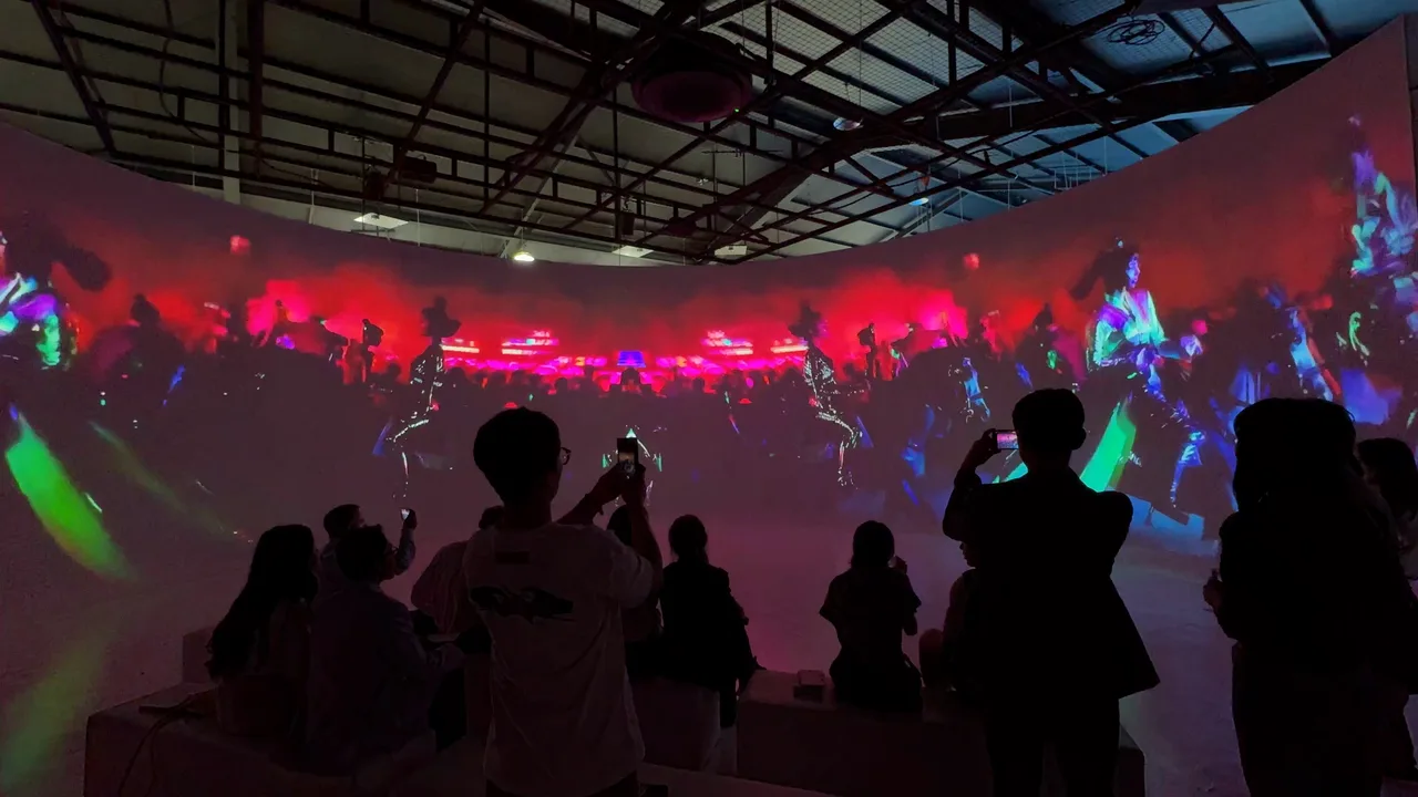 Guests in silhouette watching 2AM on a curved projection wall at the OpenAI Korea launch in Seoul.